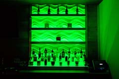 Banquet hall bar with green LED controllable lighting by Paramount Construction and Contracting