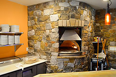 Custom stone work for stone brick oven by Paramount Construction and Contracting